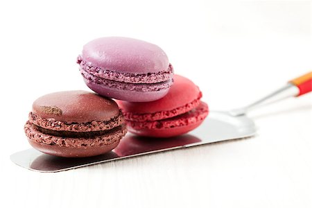 simsearch:400-06564979,k - Close-up of three colorful macaroons on cake server on light background Stock Photo - Budget Royalty-Free & Subscription, Code: 400-06556505