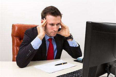 simsearch:628-05817598,k - Young concerned businessman in the office looking at computer display and thinking about business problems. Stockbilder - Microstock & Abonnement, Bildnummer: 400-06556950