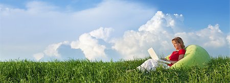 Woman with laptop computer outdoors in the fresh spring grass - panorama Stock Photo - Budget Royalty-Free & Subscription, Code: 400-06557439