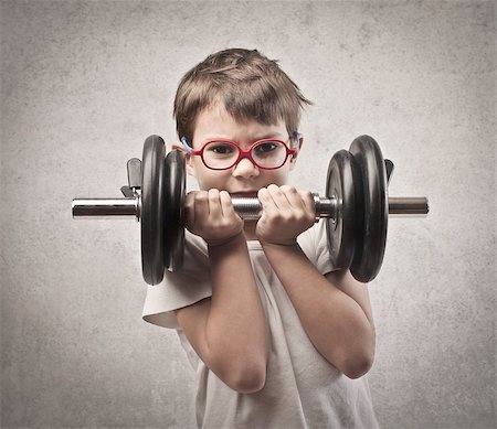 Child raising a dumbbell Stock Photo - Budget Royalty-Free & Subscription, Code: 400-06557524