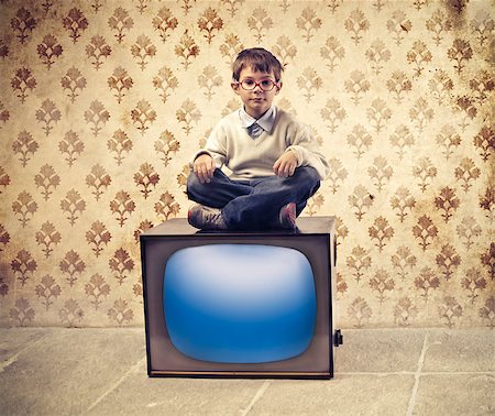 Child sitting on an old television Stock Photo - Budget Royalty-Free & Subscription, Code: 400-06557531