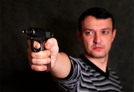 The man with a pistol on a background Stock Photo - Budget Royalty-Free & Subscription, Code: 400-06557601