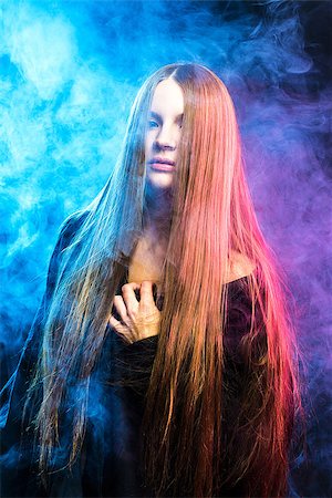 beautiful passionate girl in red and blue smoke Stock Photo - Budget Royalty-Free & Subscription, Code: 400-06557636