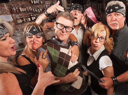 simsearch:400-06525844,k - Nerd husband and wife being cool with biker gang in bar Photographie de stock - Aubaine LD & Abonnement, Code: 400-06558609