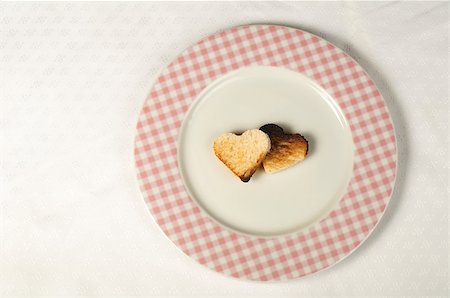 Toast with heart-shaped set in white plate Stock Photo - Budget Royalty-Free & Subscription, Code: 400-06558726