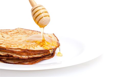 simsearch:400-04852542,k - Delicious Freshly Prepared Pancakes with Honey on white Stockbilder - Microstock & Abonnement, Bildnummer: 400-06558790