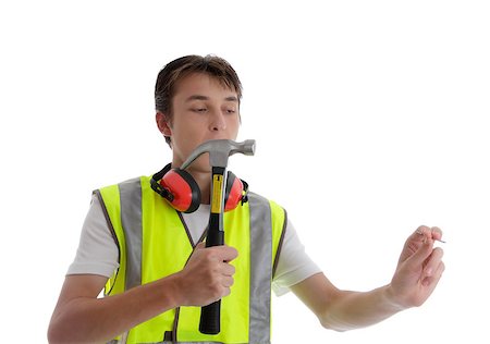 students working with tools - Apprentice teenager holding a hammer and nail.  White background. Stock Photo - Budget Royalty-Free & Subscription, Code: 400-06558955