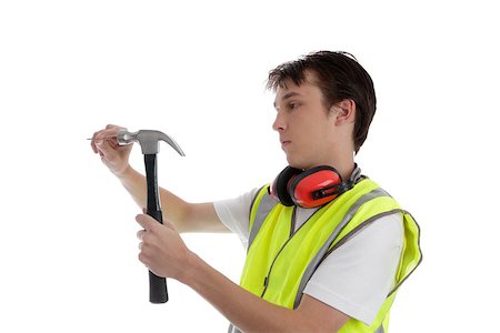 students working with tools - Teen apprentice using a hammer and nail.  White background. Stock Photo - Budget Royalty-Free & Subscription, Code: 400-06558956