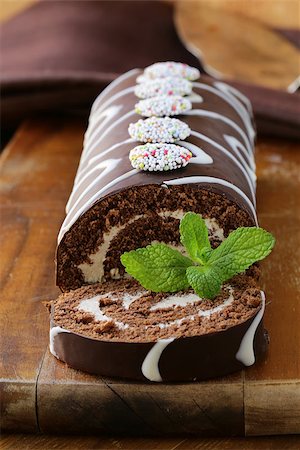 dark chocolate curl - chocolate cake  roll with vanilla cream on a wooden board Stock Photo - Budget Royalty-Free & Subscription, Code: 400-06558990