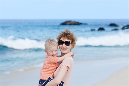 laughing mother holding her son at the beach Stock Photo - Budget Royalty-Free & Subscription, Code: 400-06559152