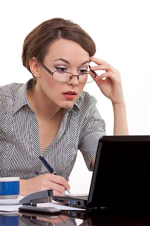 simsearch:400-04562604,k - Portrait of a successful young business woman wearing glasses working on notebook at office. Photographie de stock - Aubaine LD & Abonnement, Code: 400-06559471