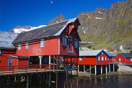 Typical red rorbu fishing huts on Lofoten islands in Norway reflecting in fjord Photographie de stock - Aubaine LD & Abonnement, Code: 400-06559695