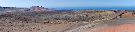 Panorama from volcanic hill on Lanzarote. Canary Islands. Timanfaya National Park. Ocean in background. Photographie de stock - Aubaine LD & Abonnement, Code: 400-06564275