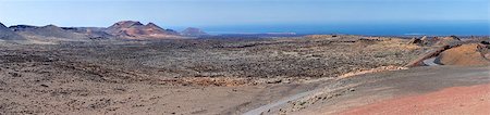 Panorama from volcanic hill on Lanzarote. Canary Islands. Timanfaya National Park. Ocean in background. Stock Photo - Budget Royalty-Free & Subscription, Code: 400-06564275