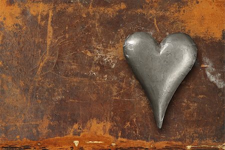 Photo of a metal heart sitting on an old leather book cover. Stock Photo - Budget Royalty-Free & Subscription, Code: 400-06564694