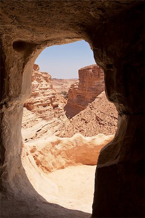 The valley of the Ein Avdat park in the Negev Desert in Israel is framed through an opening to one of the caves in the canyon walls. Stock Photo - Budget Royalty-Free & Subscription, Code: 400-06564782