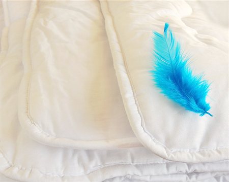 perfect bedroom - white folded cotton duvet background with blue feather Stock Photo - Budget Royalty-Free & Subscription, Code: 400-06564949