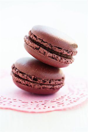 simsearch:400-06564979,k - Closeup of two chocolate macaroons on decorative pink mat Stock Photo - Budget Royalty-Free & Subscription, Code: 400-06564987