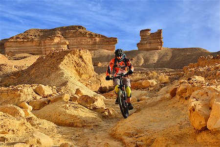 Mountain biker in a mountainous desert. Beautiful scenery and extreme sport. Stockbilder - Microstock & Abonnement, Bildnummer: 400-06565959