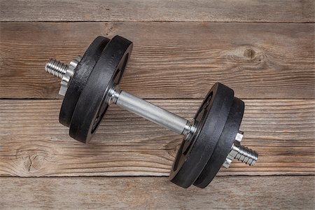 pixelsaway (artist) - exercise weights - iron dumbbell on a wooden deck Foto de stock - Royalty-Free Super Valor e Assinatura, Número: 400-06566860