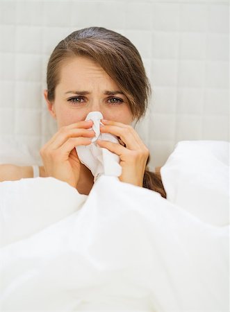 female coughing - Ill woman with hanky laying in bed Stock Photo - Budget Royalty-Free & Subscription, Code: 400-06567006