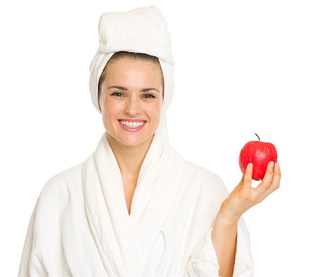 Smiling young woman in bathrobe with apple Stock Photo - Budget Royalty-Free & Subscription, Code: 400-06567036