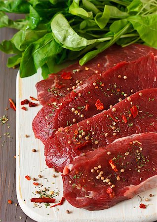 Raw beef meat  with spices and herbs on a kitchen board. Stock Photo - Budget Royalty-Free & Subscription, Code: 400-06567259