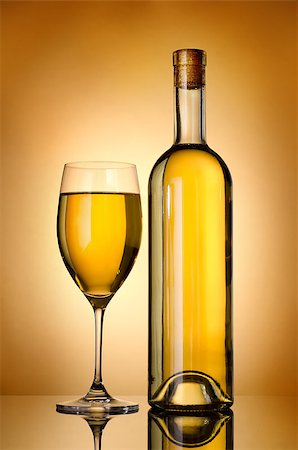 Bottle and glass of wine over gold background Stock Photo - Budget Royalty-Free & Subscription, Code: 400-06567397