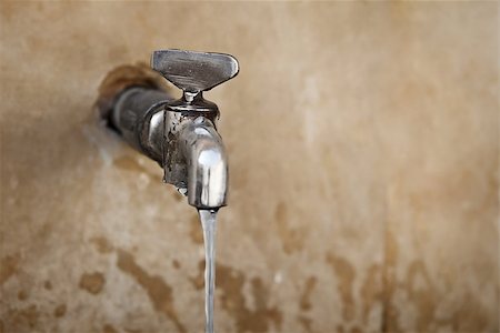 pipes on wall - Old water tap on the concrete wall Stock Photo - Budget Royalty-Free & Subscription, Code: 400-06568275