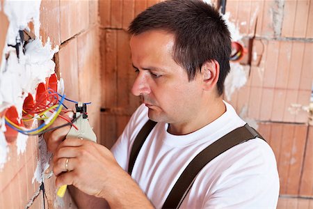 electricity man cable - Electrician working - peeling electrical wires Stock Photo - Budget Royalty-Free & Subscription, Code: 400-06568359