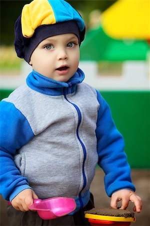 sandbox - little boy playing in the sandbox at autumn Stock Photo - Budget Royalty-Free & Subscription, Code: 400-06568853