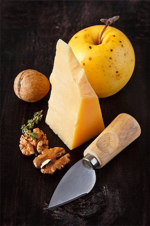 Still life with cheese, apple and walnut on a dark background. Stock Photo - Budget Royalty-Free & Subscription, Code: 400-06568906