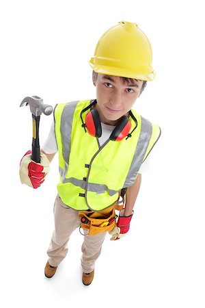 students working with tools - Above perspective view of a young apprentice builder wearing protective work gear and holding a hammer. White background. Stock Photo - Budget Royalty-Free & Subscription, Code: 400-06560174