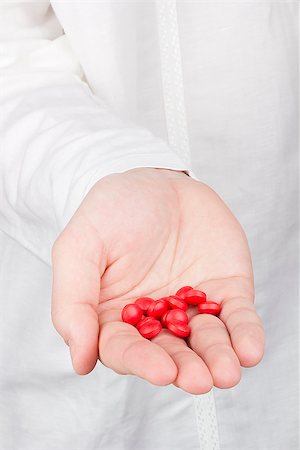 Close-up photograph of a hand holding red tablets. Stock Photo - Budget Royalty-Free & Subscription, Code: 400-06560191