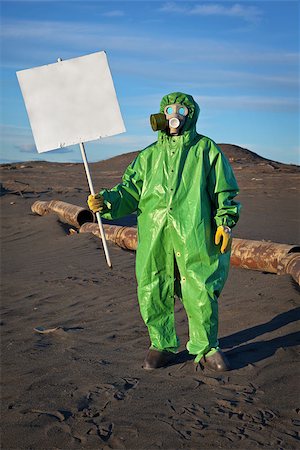 Scientist chemist with a placard in his hand in the area of chemical contamination Stock Photo - Budget Royalty-Free & Subscription, Code: 400-06560211