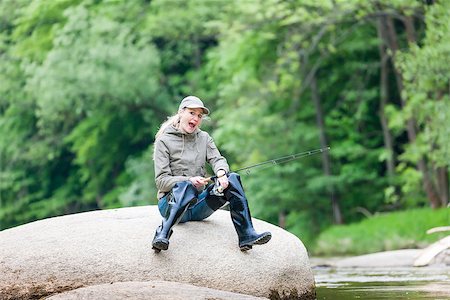 pescatrice - woman fishing in river Fotografie stock - Microstock e Abbonamento, Codice: 400-06560823