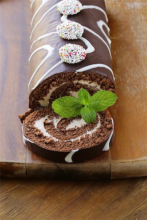 dark chocolate curl - chocolate cake  roll with vanilla cream on a wooden board Stock Photo - Budget Royalty-Free & Subscription, Code: 400-06561058