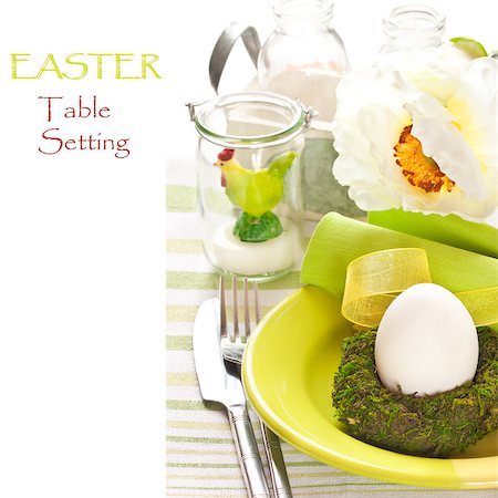 Easter table setting with green chicken candle, egg and flowers. Stock Photo - Budget Royalty-Free & Subscription, Code: 400-06561257