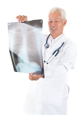 Senior adult Asian medical doctor checking on x-ray image standing isolated white background Stock Photo - Budget Royalty-Free & Subscription, Code: 400-06561646