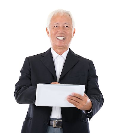 simsearch:400-07515329,k - Senior adult Asian Chinese boss using tablet-pc standing over white background Stock Photo - Budget Royalty-Free & Subscription, Code: 400-06561640