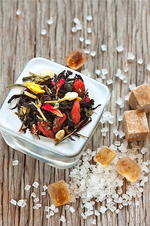 Aromatic tea with dried flowers,  goji berries and white and brown cane sugar on wooden background. Stock Photo - Budget Royalty-Free & Subscription, Code: 400-06561682