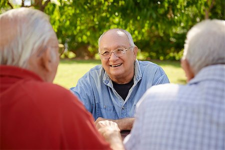 simsearch:400-06737354,k - Active retired senior people, old friends and leisure, group of four elderly men having fun, laughing and talking in city park. Waist up Stock Photo - Budget Royalty-Free & Subscription, Code: 400-06562328