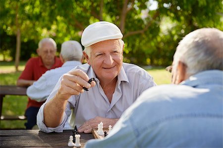 simsearch:400-06737354,k - Active retired people, old friends and free time, two seniors having fun and playing chess game at park. Waist up Stock Photo - Budget Royalty-Free & Subscription, Code: 400-06562329