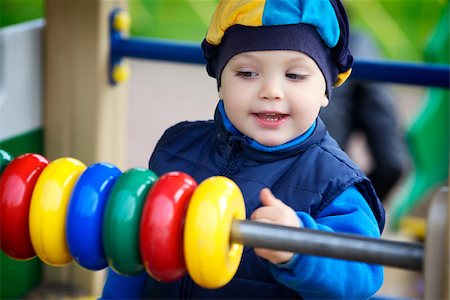 simsearch:400-06737087,k - little boy playing on playground at autumn Fotografie stock - Microstock e Abbonamento, Codice: 400-06562574