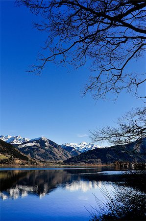 spring ski - Mountain lake landscape view with tree and mountains reflection, Zell am See, Austria Stock Photo - Budget Royalty-Free & Subscription, Code: 400-06562703