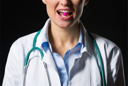 simsearch:400-07099882,k - Closeup on medical doctor woman with tablet in mouth Photographie de stock - Aubaine LD & Abonnement, Code: 400-06562769