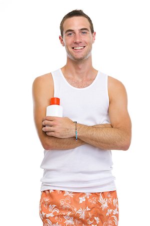 simsearch:400-07426054,k - Portrait of smiling young man showing sun screen creme Photographie de stock - Aubaine LD & Abonnement, Code: 400-06562831