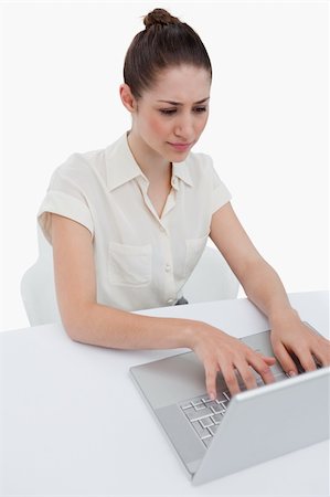 simsearch:400-08554629,k - Portrait of a young businesswoman using a laptop against a white background Fotografie stock - Microstock e Abbonamento, Codice: 400-06626997