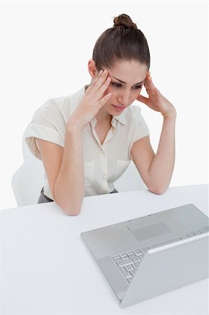 Portrait of a thoughtful businesswoman using a notebook against a white background Stock Photo - Budget Royalty-Free & Subscription, Code: 400-06626998