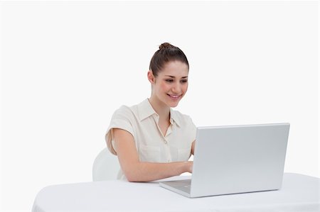 simsearch:400-08554629,k - Businesswoman using a notebook against a white background Fotografie stock - Microstock e Abbonamento, Codice: 400-06626993